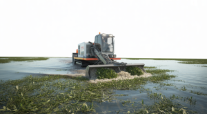 A specialized vegetation dredge machine actively removing dense aquatic plants from a clear waterway, showcasing restoration.