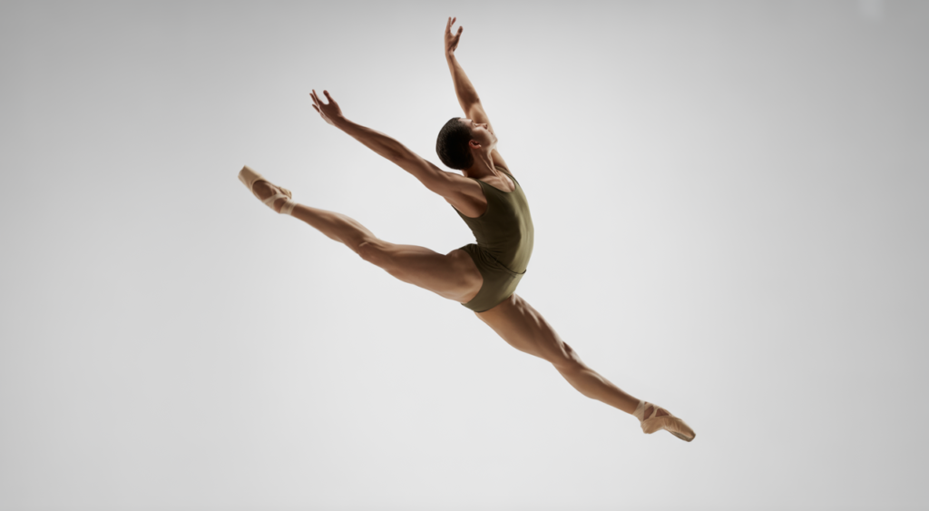 Professional ballet dancer mid-grand jeté, demonstrating grace and power.